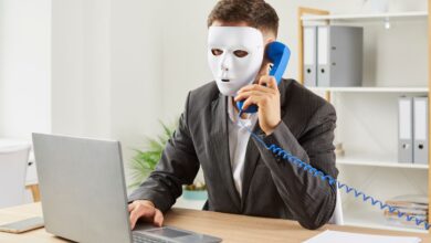 Representationa image of a man with a mask sitting with a laptop for job fraud in Hyderabad story