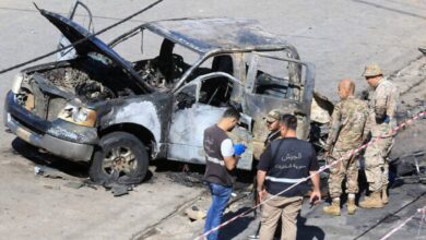 Lebanese army soldiers and forensic officers inspect a charred military vehicle following an ammunition explosion in Braiqaa, Nabatieh district, southern Lebanon.