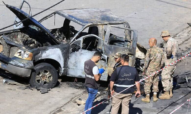 Lebanese army soldiers and forensic officers inspect a charred military vehicle following an ammunition explosion in Braiqaa, Nabatieh district, southern Lebanon.