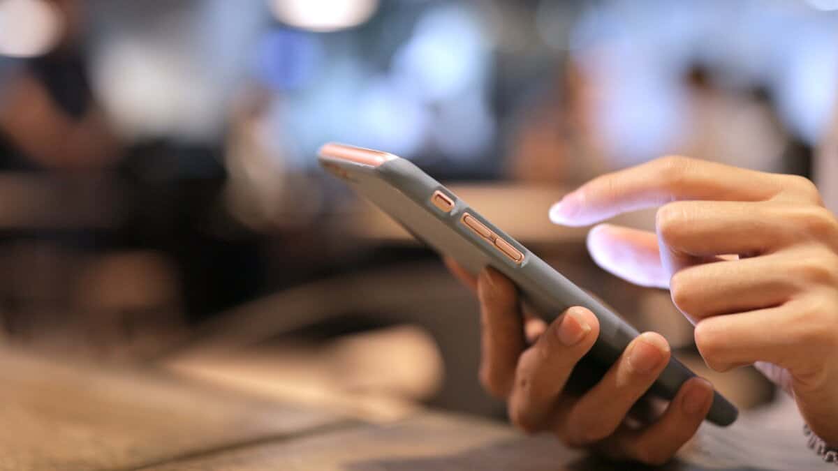 A representational image of person holding a phone