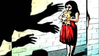 Representational Image of a mionor giorl with a teddy in her hand frightened by the silhouette of a predatory hand.