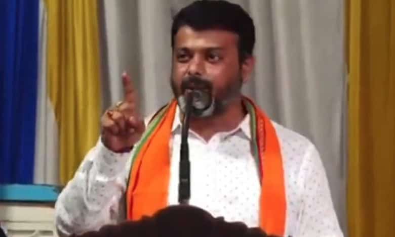 The image displays a picture of BJP MLA of Belthangady, Harish Poonja speaking at a religious ceremony at the Gopalakrishna Temple in Thekkaru village, Dakshina Kannada district.