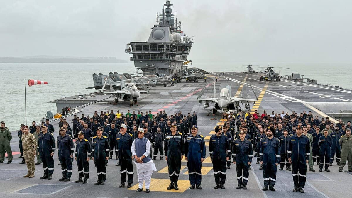 In this handout image released on May 30, 2025, Union Defence Minister Rajnath Singh with Chief of the Naval Staff (CNS) Admiral Dinesh K Tripathi and others aboard aircraft carrier INS Vikrant. (Handout via PTI Photo)