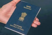 Image of an Indian passport in a person's hand.