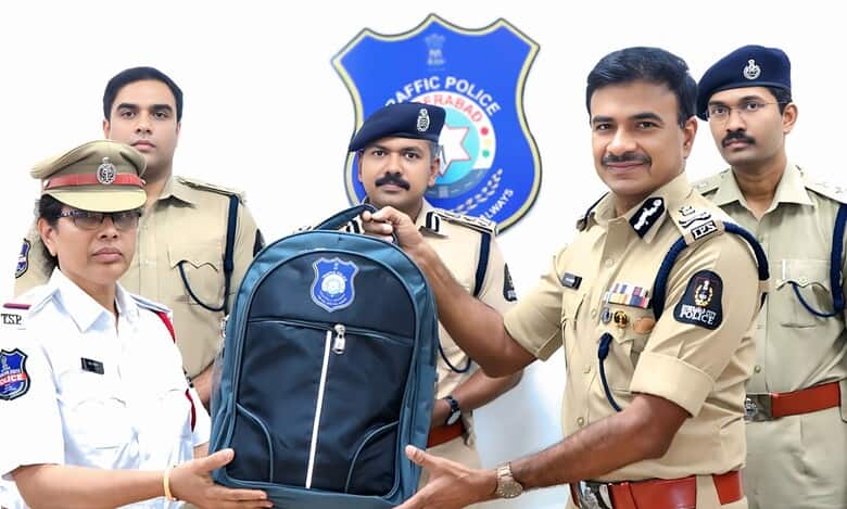 Hyderabad police commissioner CV Anand distributes a backpack with new summer friendly hats