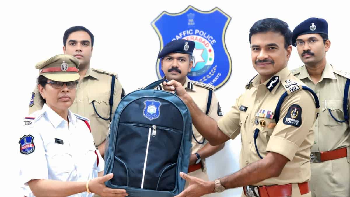 Hyderabad police commissioner CV Anand distributes a backpack with new summer friendly hats