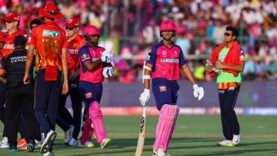Rajasthan Royals and Punjab Kings players greet each other after an IPL 2025 match, with RR batters walking off the field