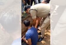Image shows authorities intervening as BJP workers halt burial over disputed 'waqf land' in Uttarakhand; standoff intensifies after youths sit inside the dug grave.