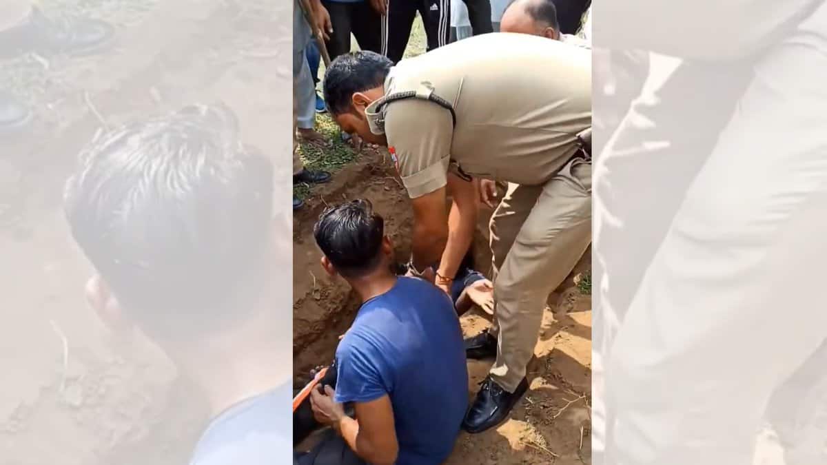 Image shows authorities intervening as BJP workers halt burial over disputed 'waqf land' in Uttarakhand; standoff intensifies after youths sit inside the dug grave.