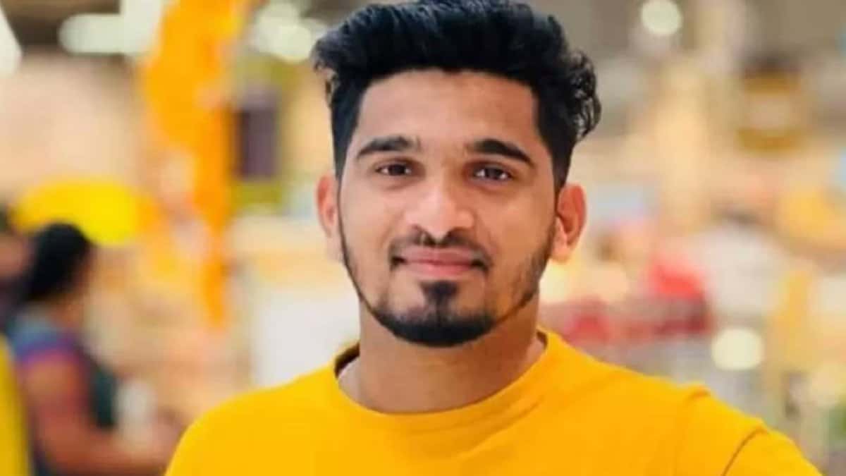 Arshad, a 26-year-old Indian employee who worked as a driver at LuLu Hypermarket in Qatar, wearing a yellow shirt and smiling.