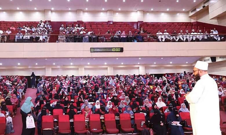 Memory Khan addressing a full auditorium during a memory improvement workshop, with participants attentively engaged in learning advanced memory techniques.