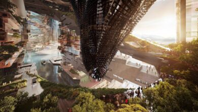 Futuristic architectural rendering of NEOM’s The Line, showing a mirrored linear city with abundant greenery, a central waterway, cruise ships, and a striking, angular black structure in the middle. People are walking along terraces and beside water features.