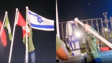 A man removes Israeli flag from the Telangana Secretariat