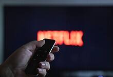 Someone switching on the TV to watch Netflix for ban on Pakistani content on OTT platforms