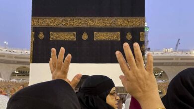 Muslim pilgrims raise their hands in prayer near the Kaaba at the Grand Mosque in Makkah during Haj.