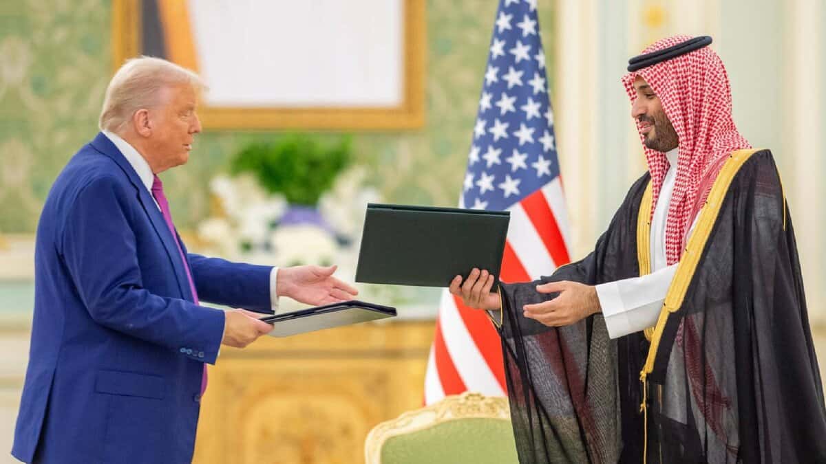Former US President Donald Trump exchanges documents with Saudi Crown Prince Mohammed bin Salman during a formal meeting in Riyadh, Saudi Arabia.