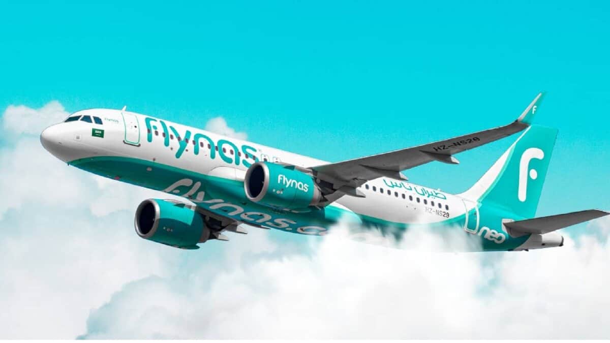 Flynas aircraft in flight above the clouds – Saudi Arabian budget airline.