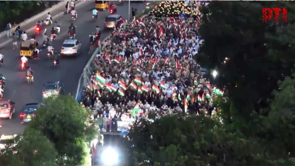 A large crowd gathers at a solidarity rally in Hyderabad on May 7, 2025, supporting the Indian Armed Forces after Operation Sindhoor against Pakistan following the Pahalgam terror attack. People wave Indian flags along a busy road with vehicles, including cars and motorcycles, visible in the background.