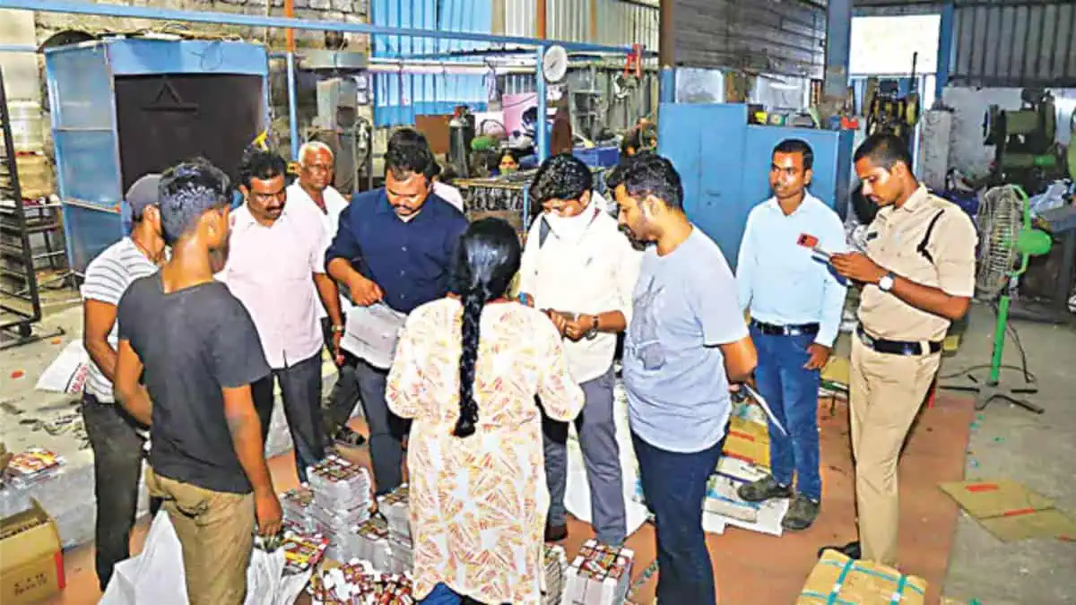 A group of people standing around in a factory