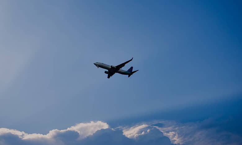 Representative image of airplane flying under blue sky