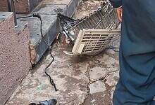 AC parts scattered on the floor with firefighters standing nearby responding to the aftermath of an AC blast in Talab Katta that injured two individuals