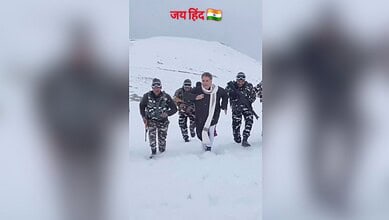 The image displays a picture of BJP leader Ravinder Raina marching in the snow surrounded by Indian Army soldiers