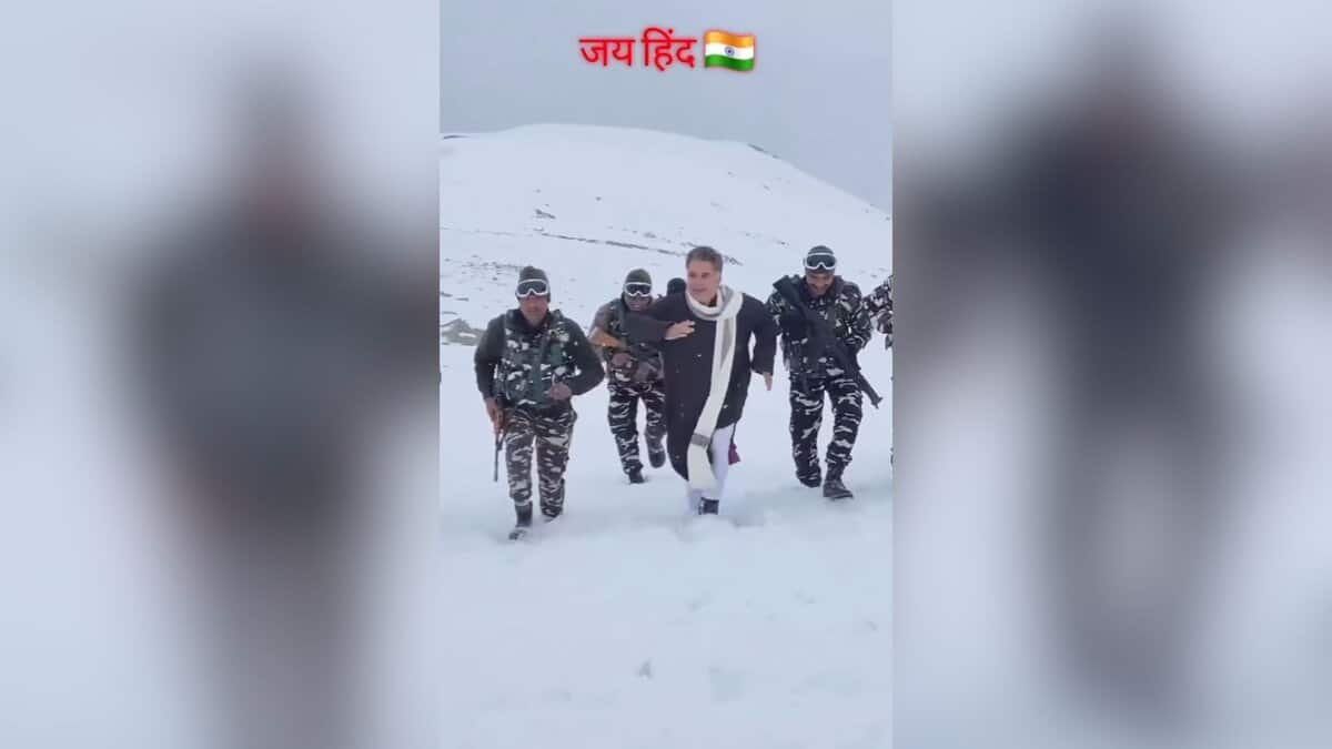 The image displays a picture of BJP leader Ravinder Raina marching in the snow surrounded by Indian Army soldiers