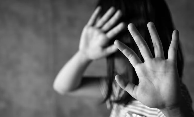 The photo displays a representational image of child abuse