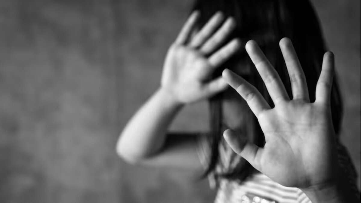 The photo displays a representational image of child abuse