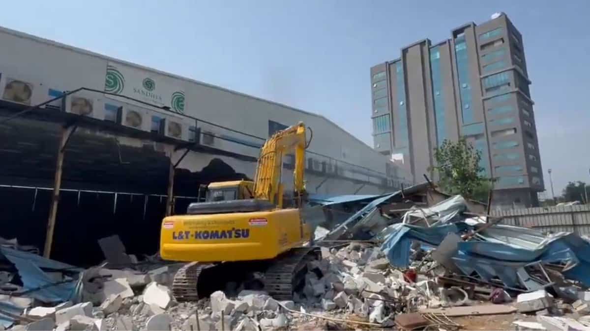 A buldozer demolishes Sandhya Convention in Gachibowli on Tuesday, May 6