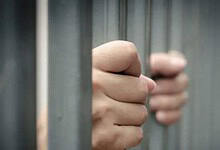 A representational image of a person in jail