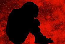 The image displays a silhouette of a boy with a red background