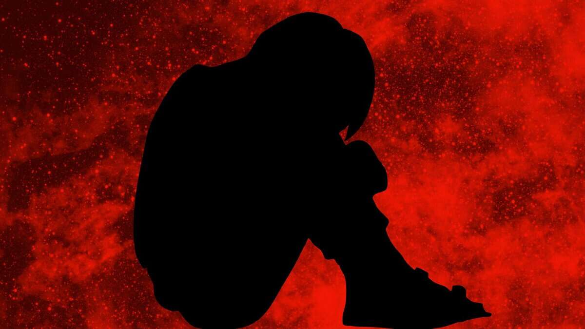 The image displays a silhouette of a boy with a red background