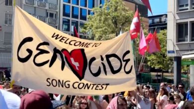 Pro-Palestine protestors hold a banner against Israel at Eurovision 2025