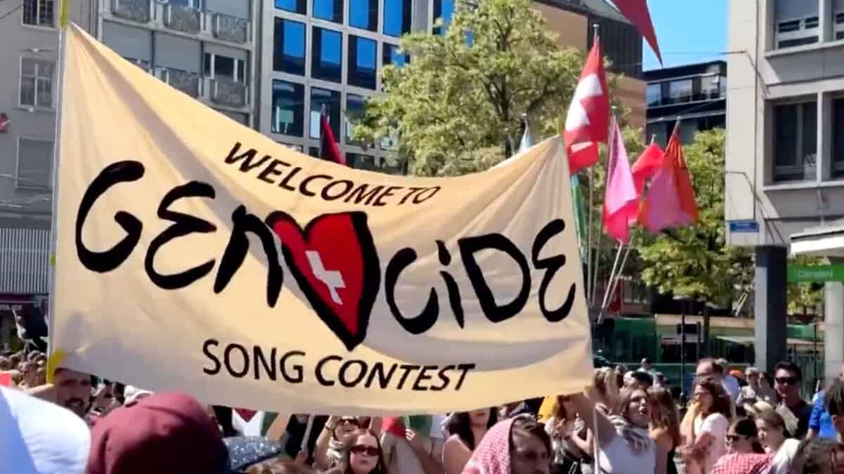 Pro-Palestine protestors hold a banner against Israel at Eurovision 2025