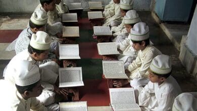 The image shows a madrasa with Muslim boys studying