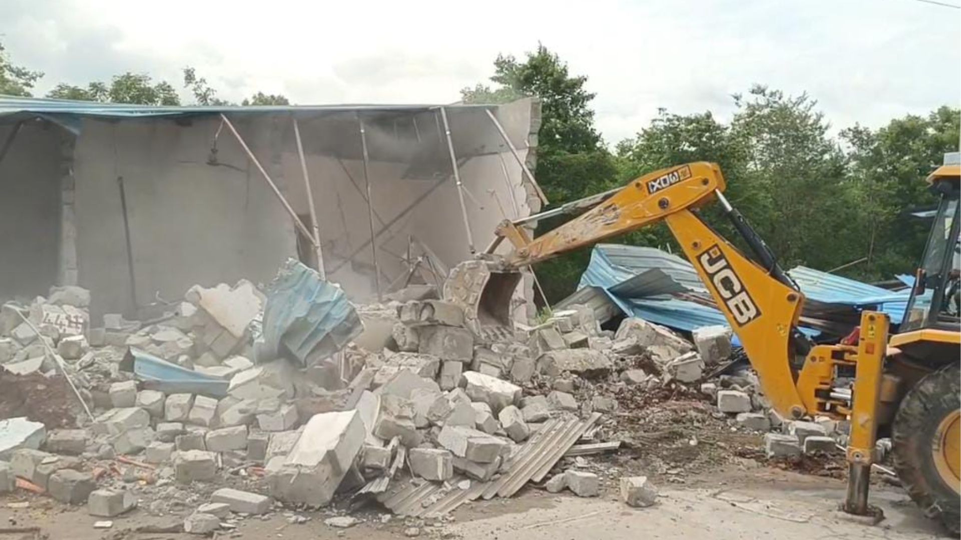 The image displays a HYDRAA demolition in Medchal-Malkajgiri district.