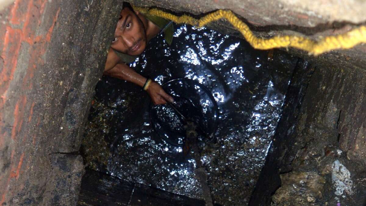 the image displays a picture of manual scavenger worker