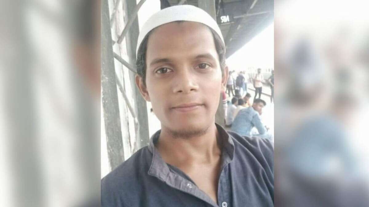 The image is a picture of a young Muslim man wearing a white skullcap