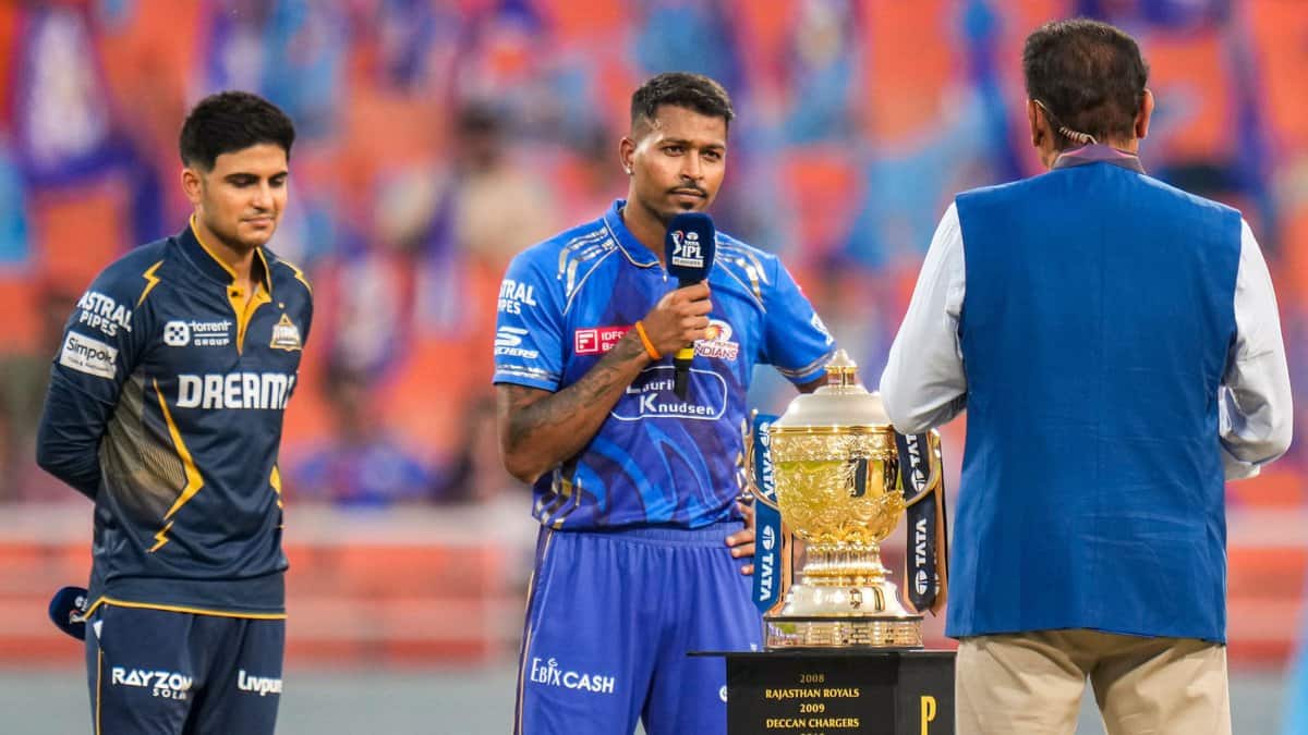 The image displays a toss between captains of Mumbai Indians and Gujarat Titans in IPL 2025