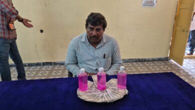 The image display a picture of a government officer in Telangana caught by ACB while taking bribe