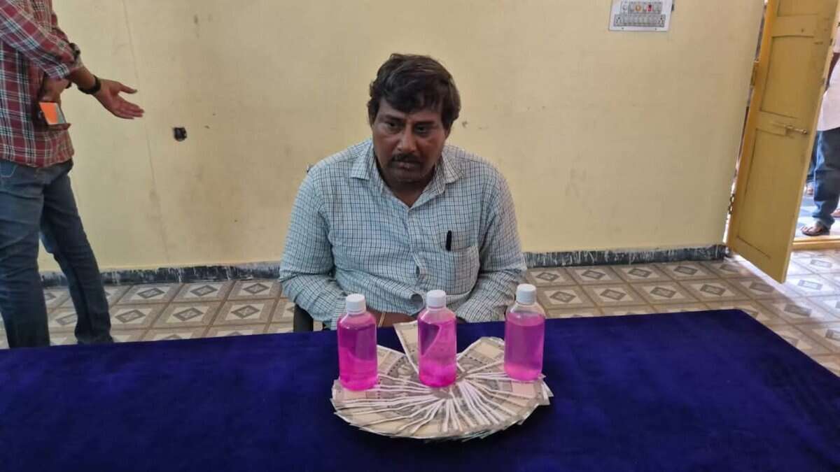The image display a picture of a government officer in Telangana caught by ACB while taking bribe