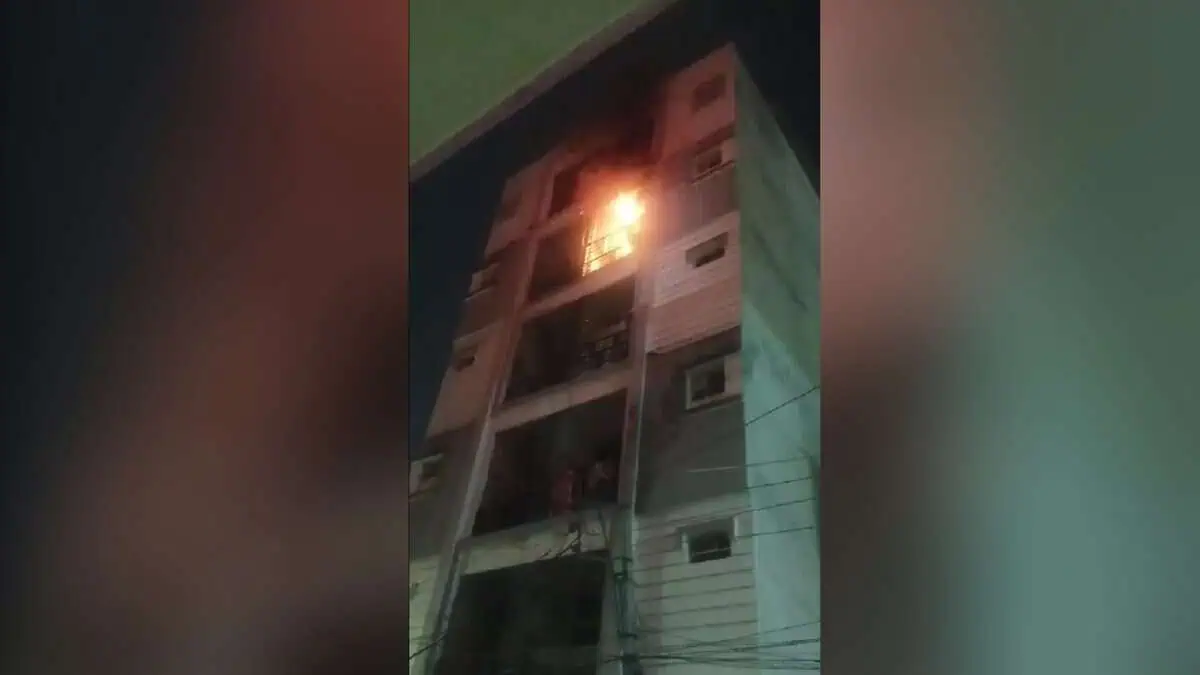 The image displays a picture of a building on fire in Hyderabad