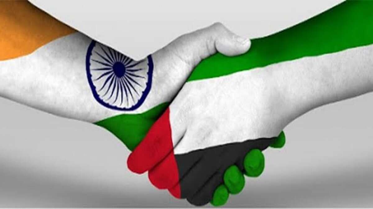 Handshake with India and UAE flags symbolizing strong bilateral relations.