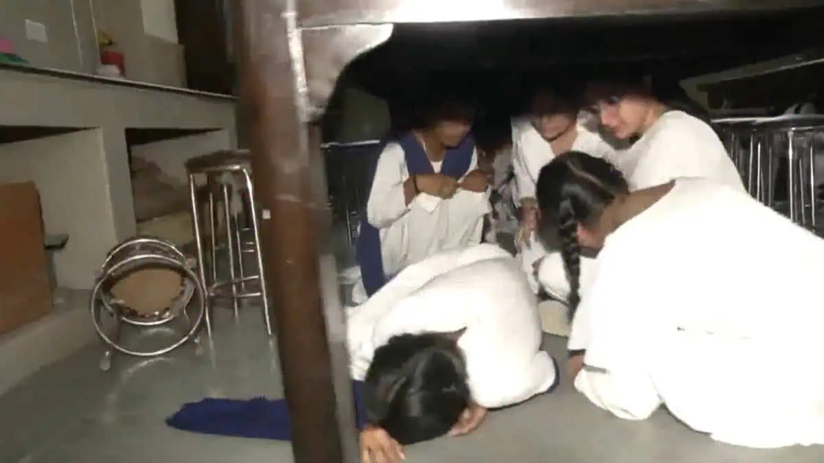 Students take shelter under the table as part of mock drill in Jammu
