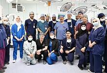 Saudi medical and surgical team poses in the operating theatre after completing a successful procedure.
