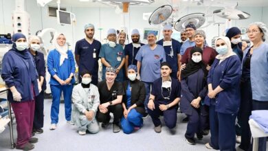 Saudi medical and surgical team poses in the operating theatre after completing a successful procedure.