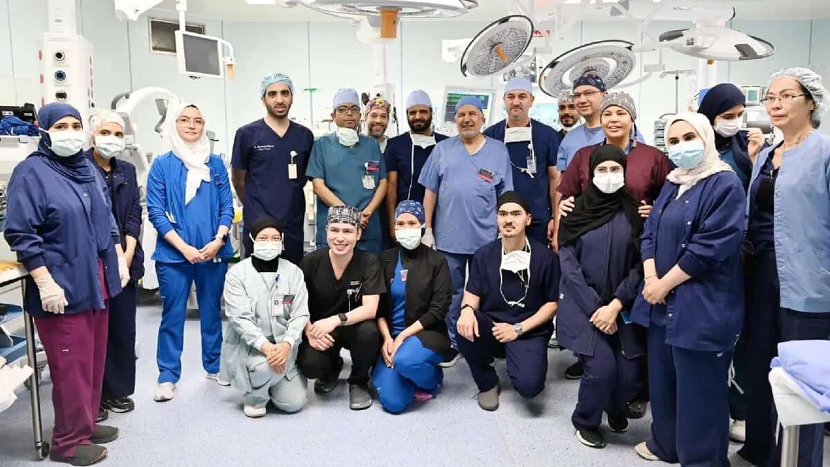 Saudi medical and surgical team poses in the operating theatre after completing a successful procedure.