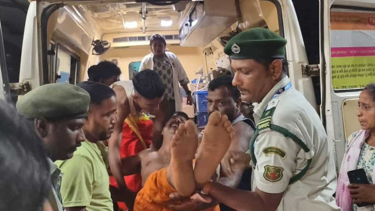 Woman carried out of ambulance by police and others after being injured in Goa temple stampede