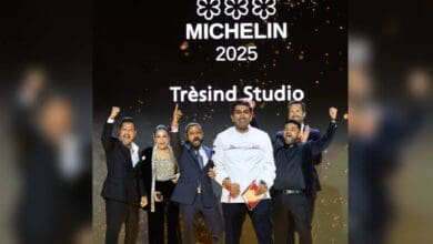 Chef Himanshu Saini stands proudly in a white chef's coat on stage with his jubilant team, celebrating Tresind Studio’s three Michelin stars at the 2025 Michelin Guide ceremony in Dubai.